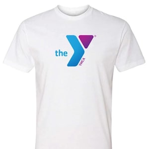May include: White t-shirt with the YMCA logo and the text "the" in blue. The Y is blue and purple.