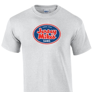 May include: A gray t-shirt with a blue and red logo that says "Jersey Mike's Subs" and "Since 1956".