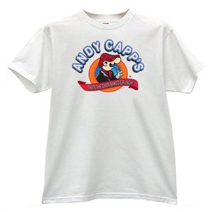 May include: White t-shirt featuring the Andy Capp's logo. The logo includes the text "Andy Capp's" in blue and a cartoon character in a red hat. Below the logo is a red banner with the text "TASTE THE OVEN BAKED CRUNCH!"