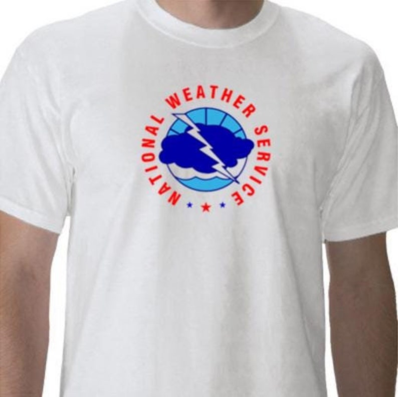 May include: White t-shirt with a red and blue National Weather Service logo. The logo features a cloud with a lightning bolt and the words "National Weather Service" in a circle.