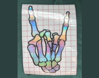 Pegatina de vinilo con forma de mano de esqueleto reflejada en arcoíris / Gesto de rock and roll