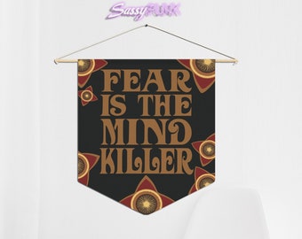 May include: Black banner with the text "FEAR IS THE MIND KILLER" in brown letters. The banner has a red and brown star pattern around the edges.