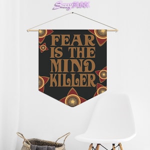 May include: Black banner with the text "FEAR IS THE MIND KILLER" in brown letters. The banner has a red and brown star pattern around the edges.