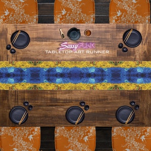 May include: A blue and yellow abstract art table runner with the text "Sassy Punk Tabletop Art Runner" on a wooden table with black plates and chopsticks.