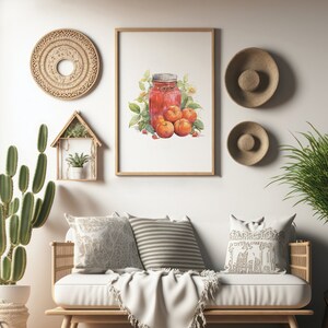May include: A watercolor painting of a jar of jam with red berries and a few green leaves. The painting is framed and hanging on a white wall above a white couch with pillows and a throw blanket. There are two woven wall hangings and a small wooden shelf with a potted plant on the wall.
