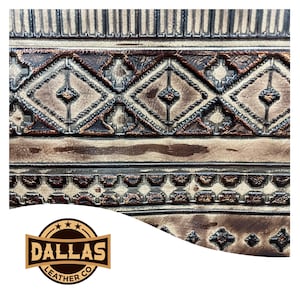 May include: Close-up of intricately tooled leather with geometric patterns in shades of brown and tan. The design features diamond shapes and linear borders. The Dallas Leather Co. logo is visible in the lower left corner.