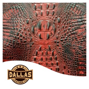 May include: Red and black alligator embossed leather with a Dallas Leather Co. logo.