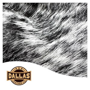 May include: Close-up of black and white cowhide leather with a wavy pattern. The leather has a soft, fuzzy texture. The Dallas Leather Co. logo is in the bottom left corner.