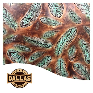 May include: Brown leather with embossed turquoise feathers. The feathers have intricate patterns and are scattered across the surface. The Dallas Leather Co. logo is in the bottom left corner.