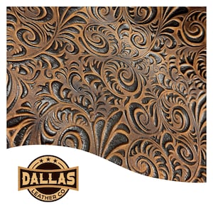 May include: Close-up of brown leather with a detailed floral pattern. The embossed design features swirling leaves and curls, creating a textured surface. The leather has a rich, warm color with darker accents, showcasing a classic, rustic aesthetic. The Dallas Leather Co. logo is in the bottom left corner.