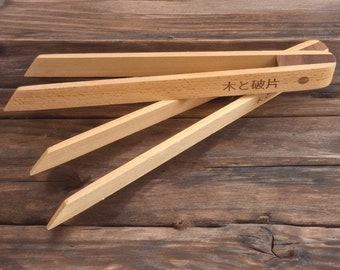 May include: Wooden tongs with a natural finish. The tongs are labeled "Wood and Plate" in Japanese characters.
