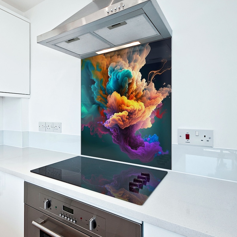 May include: A colorful abstract design printed on a glass kitchen backsplash. The backsplash is installed behind a black electric stovetop.