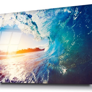 May include: A striking image of a breaking wave, with hues of blue and turquoise. The wave's crest curves over, revealing the sun setting in the distance. The artwork captures the dynamic energy of the ocean.