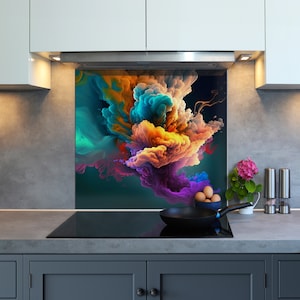 May include: A colorful abstract kitchen backsplash with a design of swirling clouds of blue, orange, purple, and green. The backsplash is installed above a black stovetop with a black frying pan and eggs on the counter.