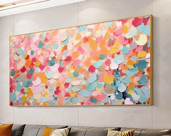 May include: Abstract painting with a colourful, textured design. The painting features a variety of shades of pink, blue, yellow, and orange. The painting is framed in a gold frame.