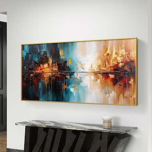 Puede incluir: Pintura abstracta con marco dorado, que representa una ciudad reflejada en el agua. La pintura está en tonos de azul, marrón, naranja y blanco.