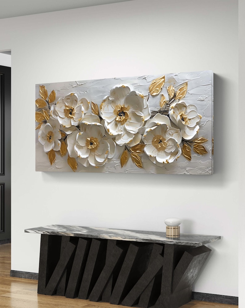 May include: White and gold floral painting on canvas with a textured, 3D effect. The flowers are arranged in a horizontal row and have a realistic appearance.