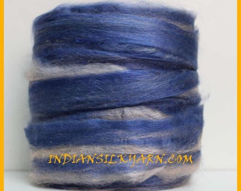 May include: A roll of blue and white silk yarn. The yarn is made of natural fibers and is perfect for knitting or crocheting. The yarn is labeled "INDIAN SILKYARN.COM".