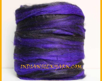 May include: A close-up of a skein of black and purple silk yarn. The yarn is soft and fluffy, and it is perfect for knitting or crocheting.
