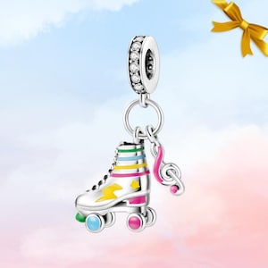 May include: Silver charm featuring a roller skate and a musical note pendant. The roller skate is white with colourful stripes, a yellow lightning bolt, and pink, blue, and green wheels. The charm has a ring of clear stones.