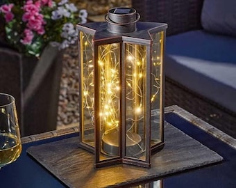 Linterna Starlight con luces LED blancas cálidas, 32 cm, color cobre, alimentada por energía solar.