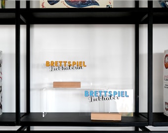 Board game lover: Show your love for board games with this unique shelf decoration – a must-have for all board game fans.