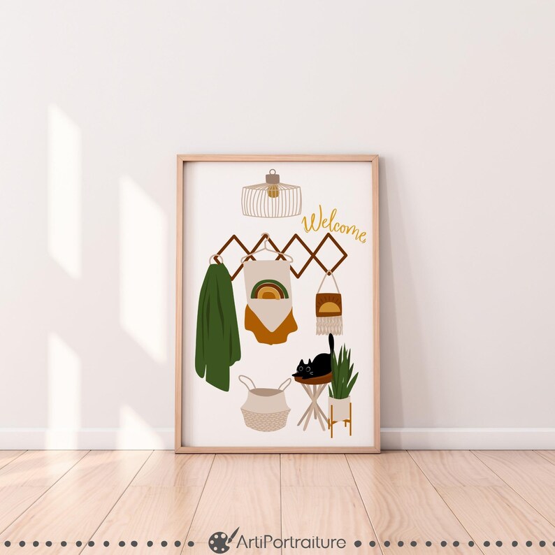 May include: A framed print with a welcome sign, a black cat, a plant, a basket, and a hanging rack with a rainbow design. The print has a white background and a wooden frame.