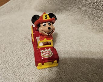 vintage Tomy die-cast toy featuring Mickey Mouse in a fire truck