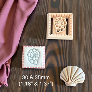 May include: A selection of seashell-themed cookie cutters and a seashell-shaped object. The cutters are square and rectangular, with a seashell design. The text on the image reads "30 & 35mm (1.18" & 1.37")". The objects are beige and white.