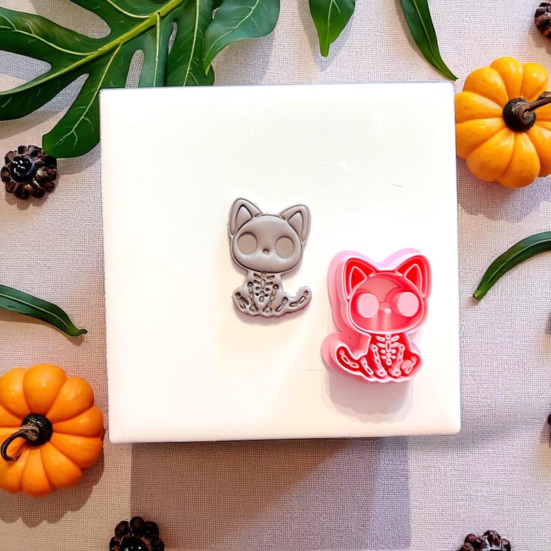 Spooky cat skeleton cutter with matching clay result side by side