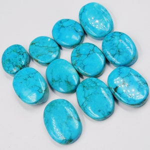 May include: Ten oval-shaped turquoise cabochons with a blue-green color and a marbled pattern.