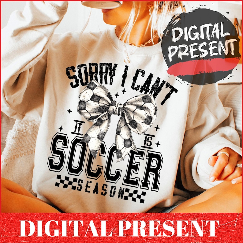 May include: White sweatshirt with a black and white graphic design that says "Sorry I can't it is soccer season" with a black and white soccer ball bow.