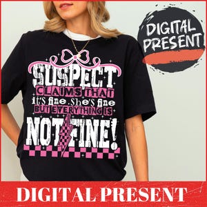 May include: Black t-shirt with a pink graphic that says "SUSPECT CLAIMS THAT it's fine. She's fine BUT EVERYTHING IS NOT FINE!" with a pink lightning bolt and checkered pattern.
