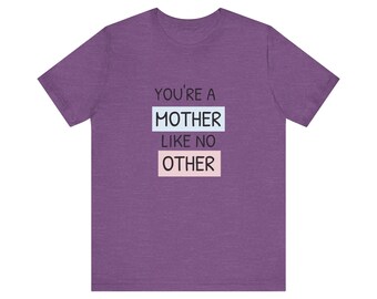 May include: Purple short-sleeved t-shirt with the text "You're a Mother Like No Other" in black text with a light blue and pink background.