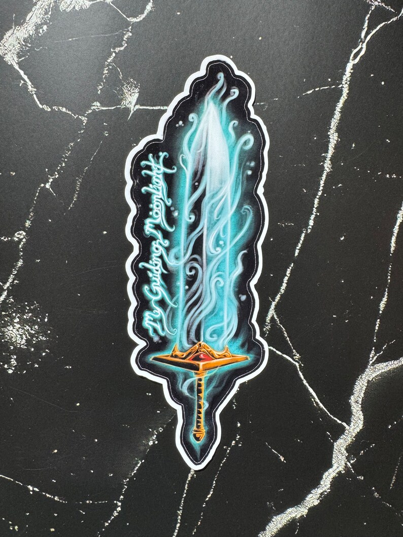 May include: A sticker of a glowing blue sword with a gold hilt and a red jewel. The sword is surrounded by blue flames and the text "My Guiding Moonlight" is written on the side.