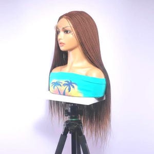 May include: A white ceramic mug with a black handle and the text "But First, Coffee" in a handwritten style. The mug is on a white surface. The mug is approximately 4 inches tall.