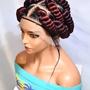 May include: A set of three ceramic mugs with a speckled, cream-colored glaze. Each mug features a different hand-painted design: a blue and green leaf, a yellow flower, and a red berry. The mugs have a simple, modern design.