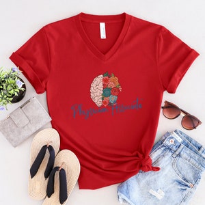 May include: Red V-neck t-shirt with a floral brain graphic and the text "Physician Associate" in blue script.
