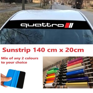 May include: Black sunstrip with the word "quattro" in white and red accents. The sunstrip is 140 cm long and 20 cm high. The image also shows a selection of coloured vinyl rolls and a blue applicator tool.