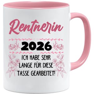 May include: White ceramic mug with a pink interior and handle. The mug features the word "Rentnerin" in pink script, the number "2026", and German text. Floral and leaf accents surround the text.