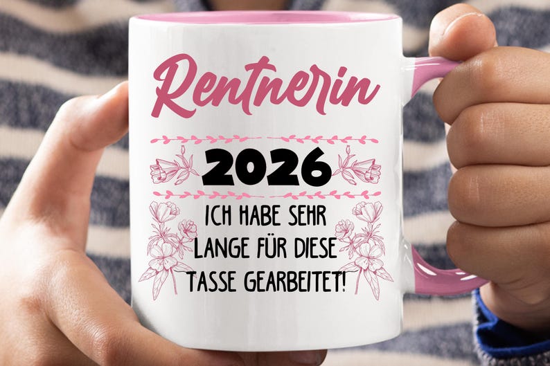 May include: White ceramic mug with a pink interior and handle. The mug features the text "Rentnerin 2026" in pink script, along with the phrase "ICH HABE SEHR LANGE F&Uuml;R DIESE TASSE GEARBEITET!" in black, and floral accents.