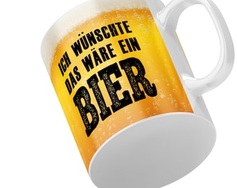 May include: White ceramic mug with a handle. The mug has a graphic of a beer glass with the text "Ich wünschte das wäre ein Bier" printed on it.