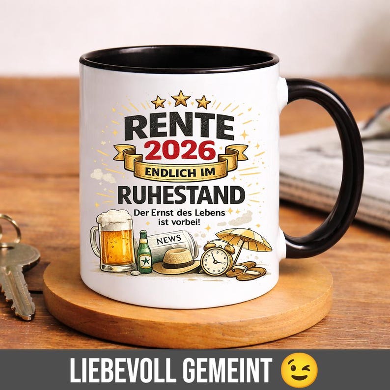 May include: White ceramic mug with a black interior and handle. The mug features text and illustrations related to retirement, including the year 2026, a beer, a newspaper, and a hat. The mug is on a wooden coaster.