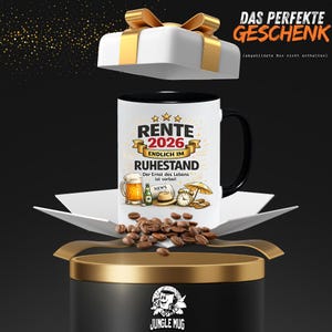 May include: A white coffee mug with a black handle and rim, featuring the text "RENTE 2026 ENDLICH IM RUHESTAND" and illustrations of beer, a hat, and an umbrella. The mug is presented as a gift.