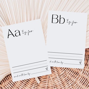 May include: Two white cards with black lettering. The first card says "Aa is for" and the second card says "Bb is for". Both cards have lines for writing and a small heart at the bottom.