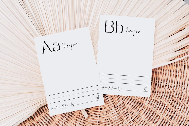 May include: Two white cards with black lettering. The first card says "Aa is for" and the second card says "Bb is for". Both cards have lines for writing and a small heart at the bottom.