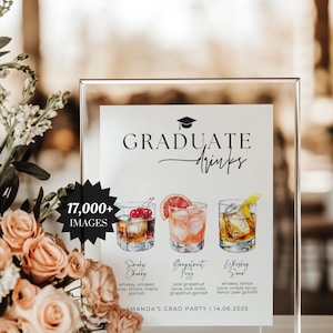May include: A clear acrylic sign with the words "GRADUATE DRINKS" and illustrations of three cocktails: Smoky Cherry, Grapefruit Fizz, and Whiskey Sour. The sign also includes the text "AMANDA'S GRAD PARTY | 14.06.2025" and "17,000+ IMAGES".