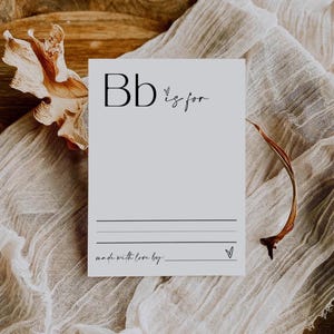 May include: A white card with the letter "B" in black and the text "B is for" in black cursive. The card has a line for writing and the text "made with love by:" at the bottom.