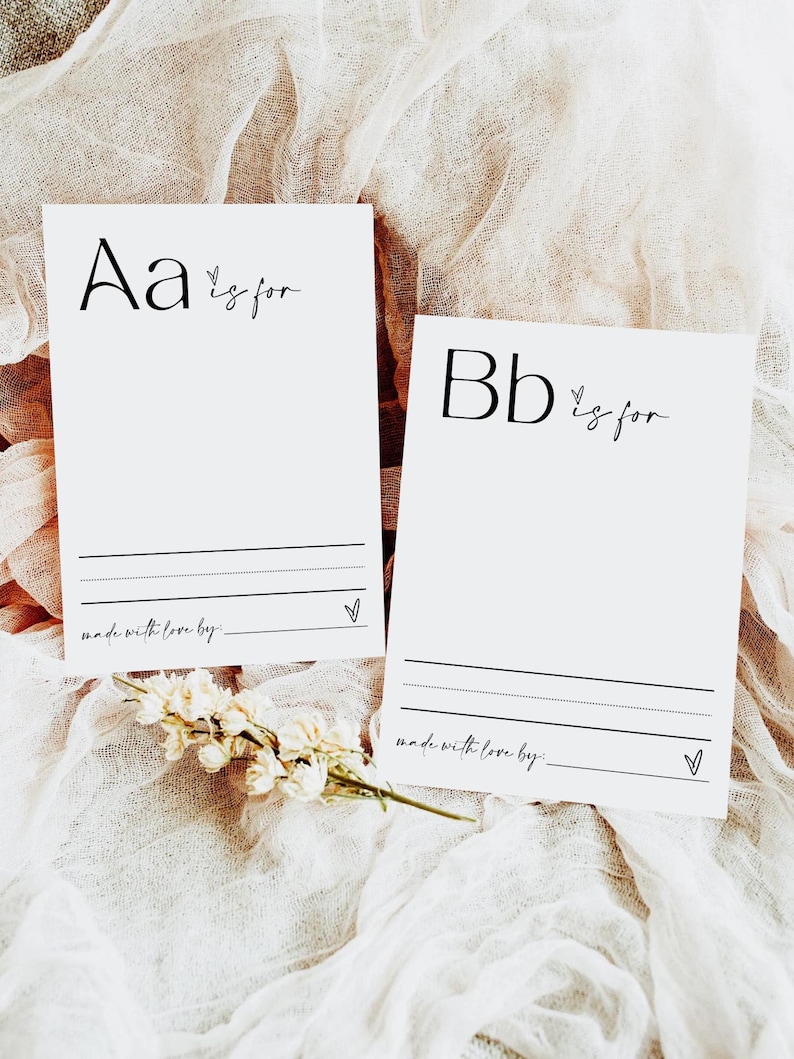 May include: Two white cards with black lettering. The first card says "Aa is for" and the second card says "Bb is for". Both cards have a small heart symbol and a line for writing.