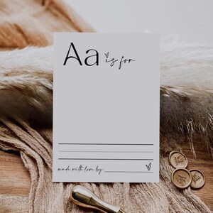 May include: A printable card with the letter "A" and the text "A is for" followed by a blank line for writing. The card also has the text "made with love by:" followed by a blank line for writing. The card is on a brown surface with a gold wax seal.